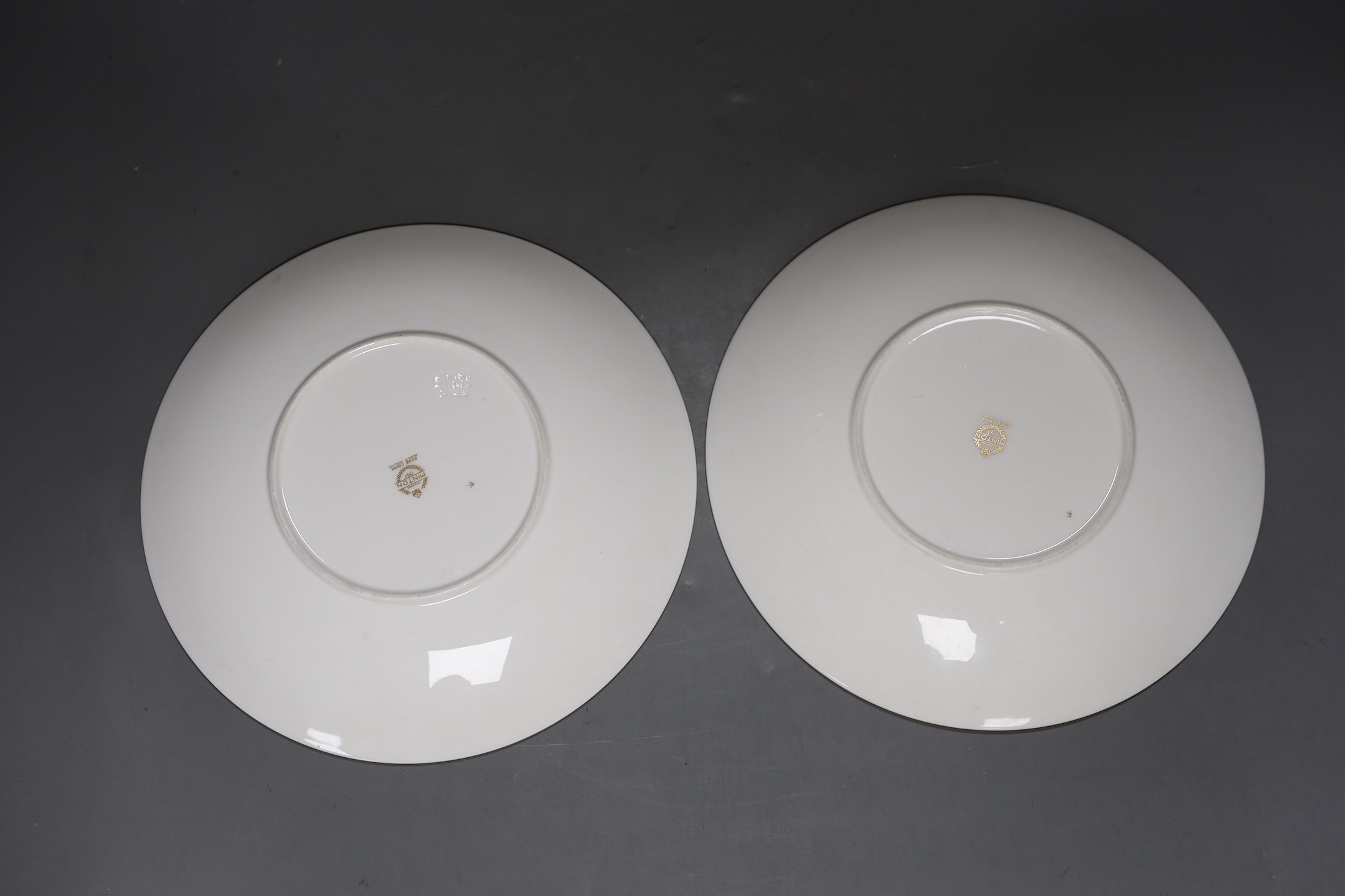 A pair of Minton fruit painted plates, signed A. Holland, 23cm diameter, together with two books on Coalport
